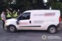 White panel van stopped on a road; four police officers in high-visibility vests speak with a man; Ukrainian National Police logo appears bottom-right.