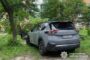 Gray SUV with rear-end damage parked on grassy ground under trees; Ukrainian police watermark in bottom-right corner.
