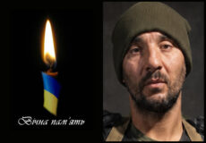 Left: lit candle with blue and yellow ribbon and Ukrainian text 'Вічна пам'ять' indicating eternal memory; Right: man wearing an olive beanie, looking at the camera with a somber expression.