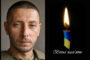 Left: man in military clothing; right: lit candle with blue-yellow ribbon and the Ukrainian text 'Вічна пам'ять'—a memorial tribute.