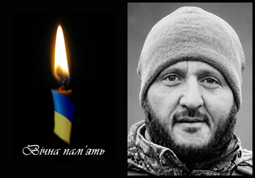 Two-panel memorial: left side shows a lit candle with blue and yellow ribbon and the text 'Вічна пам'ять' on a black background; right side is a grayscale close-up portrait of a bearded man wearing a beanie.