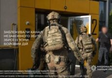 Soldiers in camouflage gear approach a yellow door, entering a building during a security operation in Ukraine.