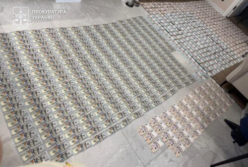 Rows of identification cards spread on a tiled floor, with a Ukrainian prosecutor's office watermark in the corner.