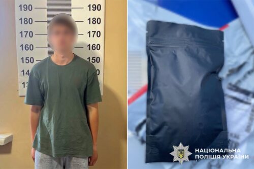 Blurred man in a green shirt stands before a height chart at a police station; to his right is a sealed black evidence bag with Ukrainian police emblem.