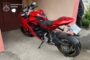 Red sport motorcycle parked by a pink wall, with a blurred license plate; Ukrainian Prosecutor's Office watermark in the top left.