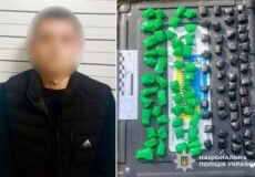 Blurred man in a dark jacket beside a police evidence tray filled with green and black drug packages.