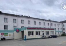 Wide view of a public medical facility with a pale building, teal entrance awning, and parked cars outside; Ombudsman of Ukraine watermark in the top-right corner.