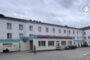 Wide view of a public medical facility with a pale building, teal entrance awning, and parked cars outside; Ombudsman of Ukraine watermark in the top-right corner.