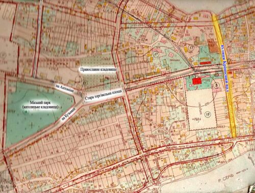 Old printed city map in Cyrillic, showing streets, a large park on the left, and a river to the right.