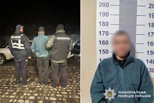 Two police officers in dark uniforms stand with a handcuffed man at night on a cobblestone surface; their backs are to the camera.