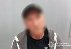 Blurry photo of a man wearing a dark shirt and gray hoodie, with the National Police of Ukraine watermark in the corner.