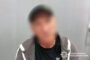 Blurry photo of a man wearing a dark shirt and gray hoodie, with the National Police of Ukraine watermark in the corner.