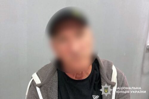 Blurry photo of a man wearing a dark shirt and gray hoodie, with the National Police of Ukraine watermark in the corner.