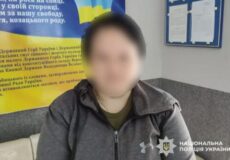 Person with blurred face sits in a police interview room; Ukrainian flag banner and police watermark are visible in the background.